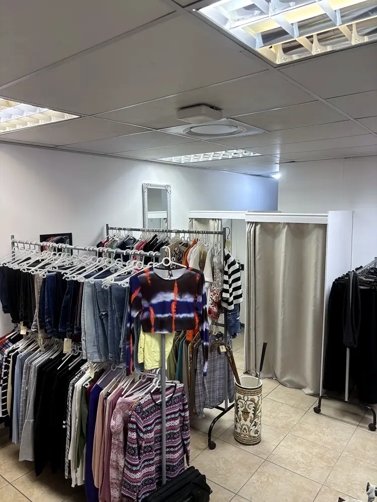 Racks of second-hand clothing inside Encore